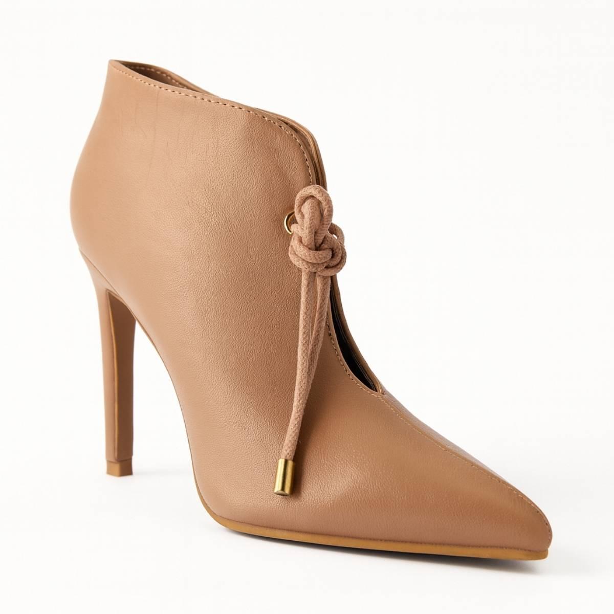 Close-up of Oh! Divine nude stiletto heel showing gold-tipped lace detailing and polished finish.