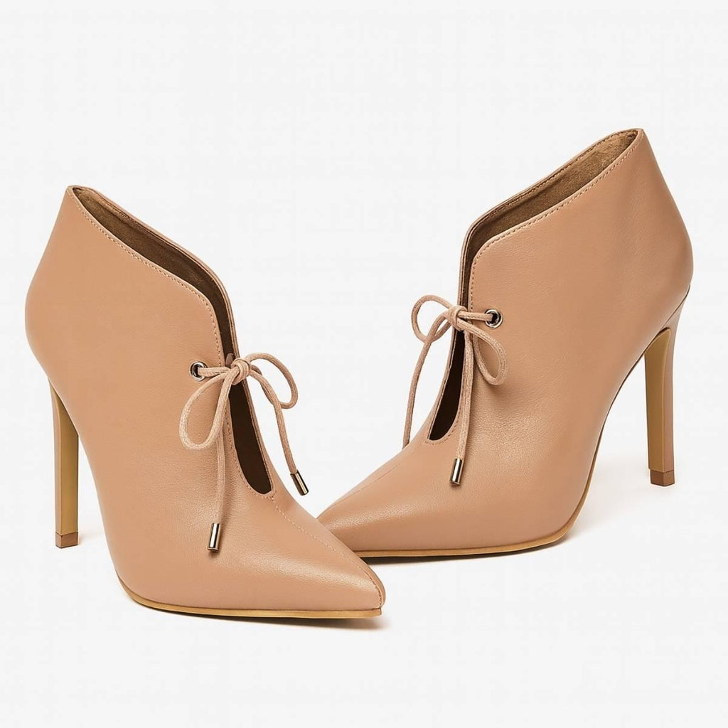 Oh! Divine nude lace-up stiletto heels photographed at an angle to reveal their sculpted high-heel shape.