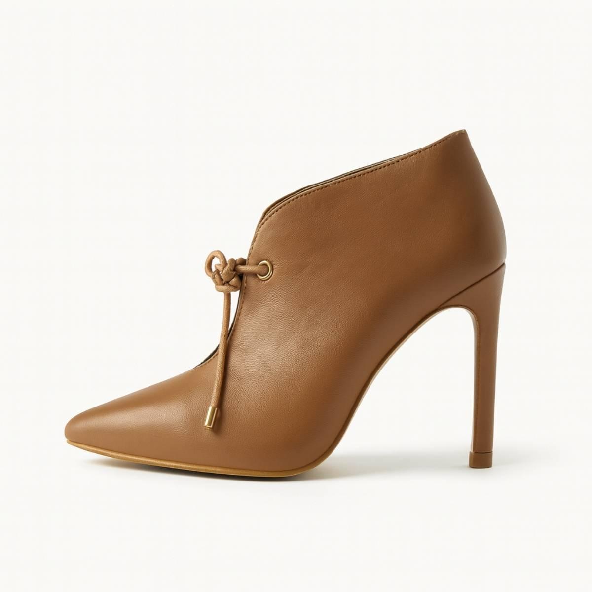 Side view of Oh! Divine nude pointed-toe stiletto heel featuring sleek silhouette and soft faux leather texture.