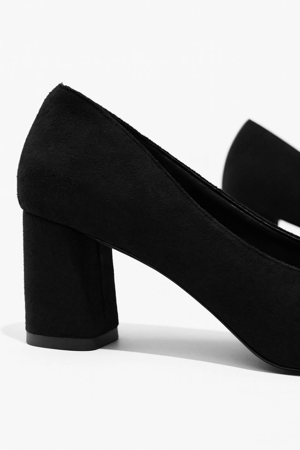 Back angle showing Amara Noir Chain Block Heels with smooth block heel design.