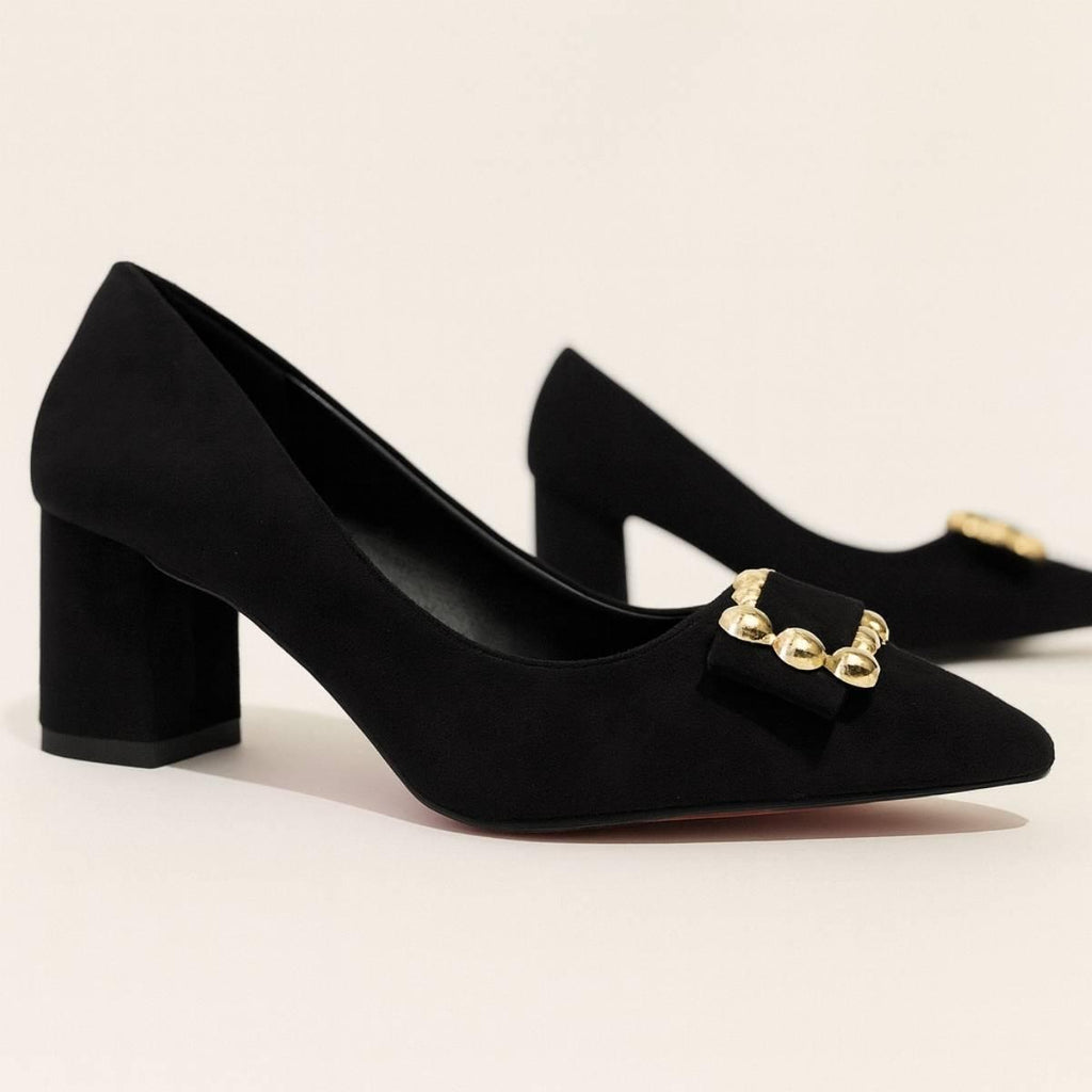 Pair of Amara Noir Chain Block Heels showing gold embellished bows on pointed toes.