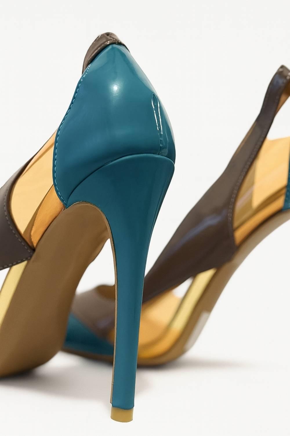 Detailed shot of Aria Colour Block Stiletto heel, displaying teal patent shine and precise craftsmanship.