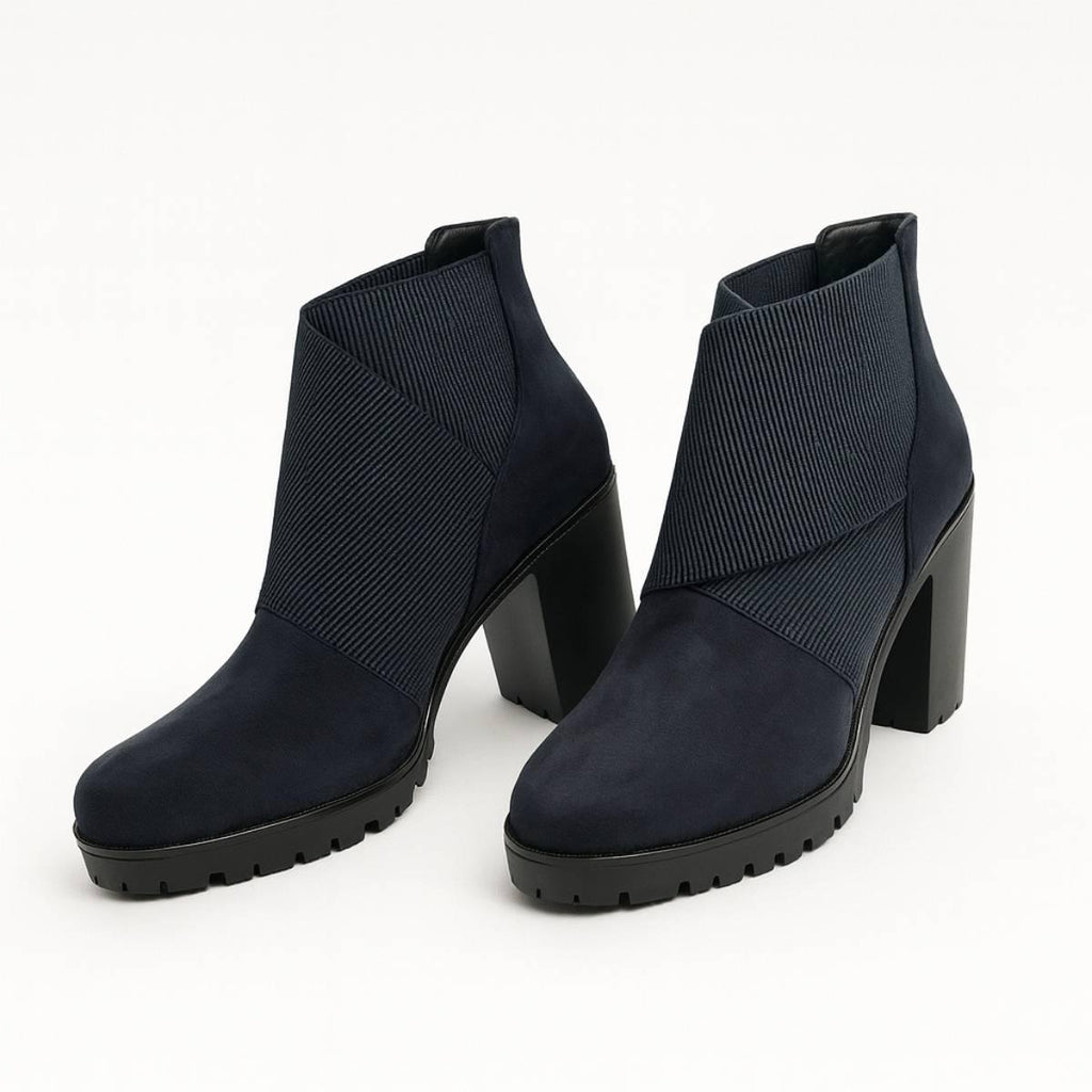 Pair of Celeste Navy Block Heel Ankle Boots in navy suede with structured block heels.