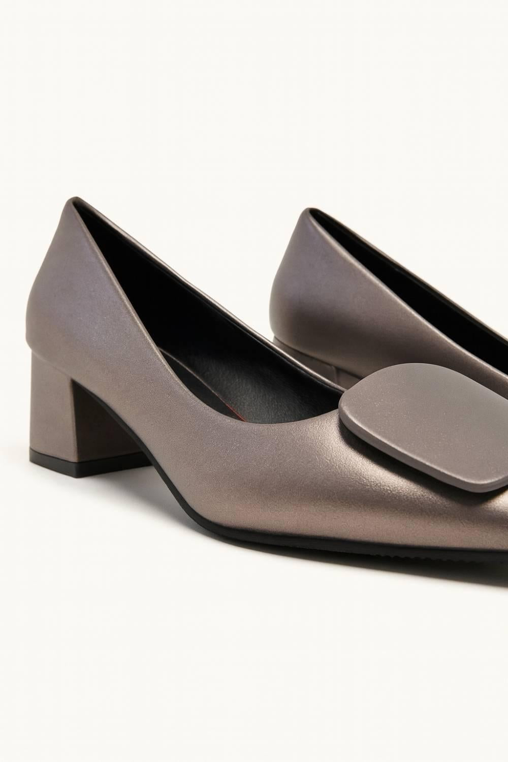 Studio close-up of Elara Bronze Sculpted Block Heel emphasizing modern structure and smooth metallic tone.