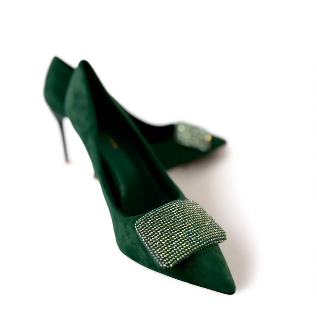 Detailed shot of the Emerald Grace Stiletto showcasing shimmering crystal buckle and deep green suede texture.