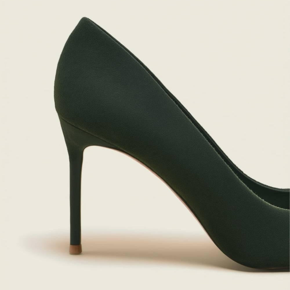 Close-up focus on the heel of the Emerald Grace Stiletto — luxury suede craftsmanship by Oh! Divine Fashion.