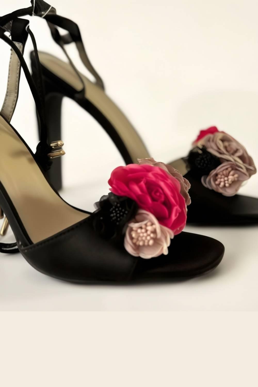 Close-up of Oh! Divine floral-embellished black heels with layered fabric flowers in blush, rose, and black.