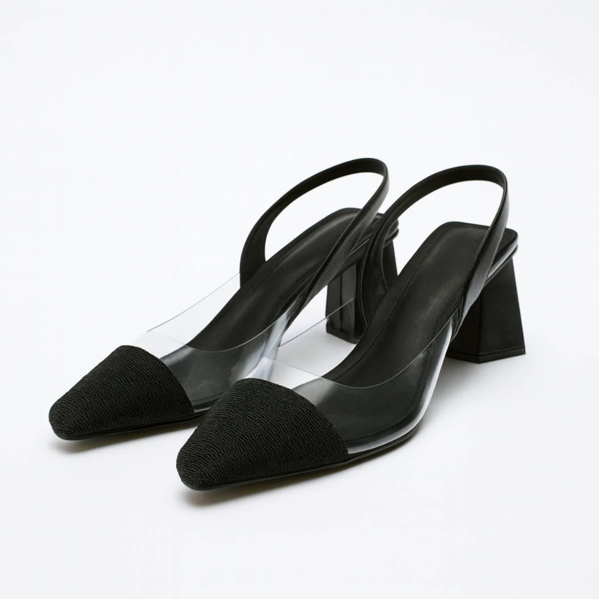Elegant angle view of Lucent Noir Block Heels in black with transparent PVC panel and block heel