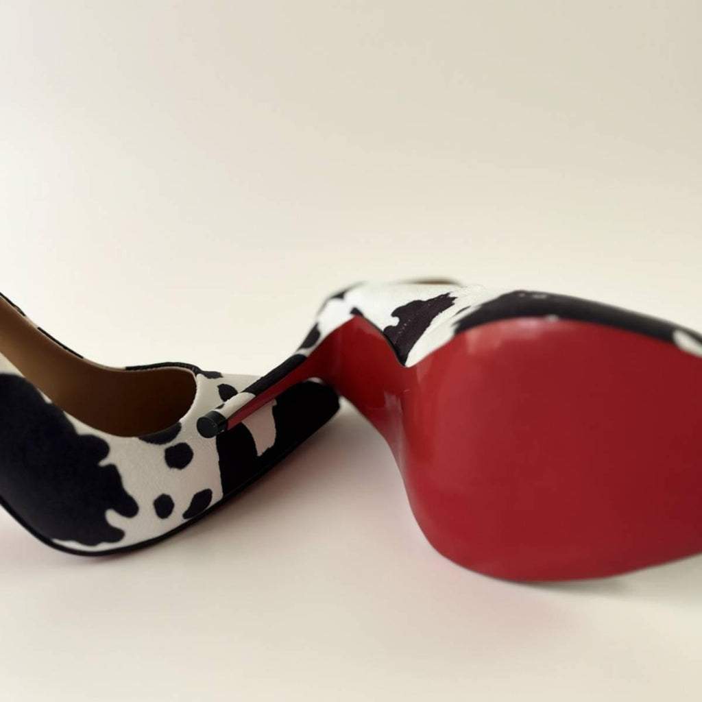 Bottom view of Noir Cowhide Stiletto with glossy red sole and sculpted heel.