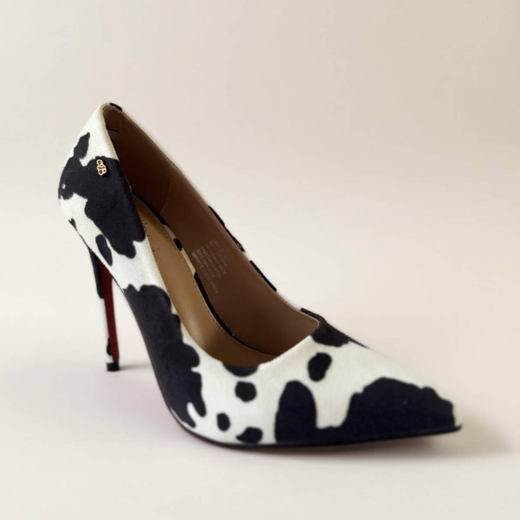 Front angle of Noir Cowhide Stiletto featuring monochrome cowhide texture and red sole.