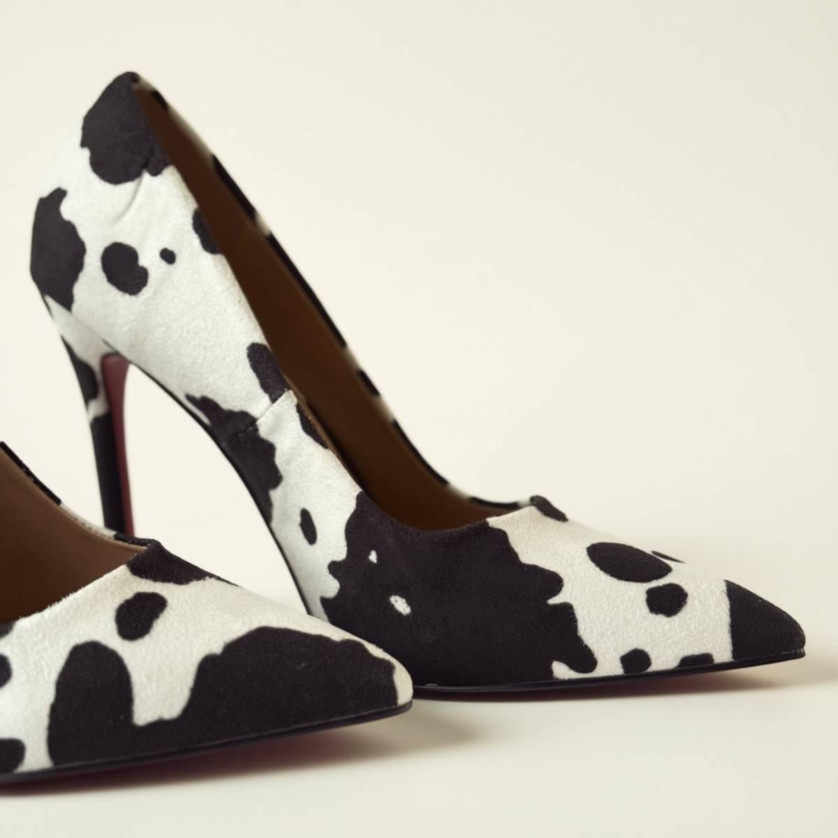 Close-up of Noir Cowhide Stiletto pair highlighting pointed toe and texture.