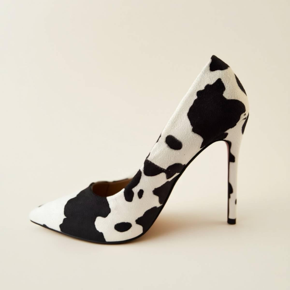 Side profile of Noir Cowhide Stiletto in bold black-and-white cowhide print.