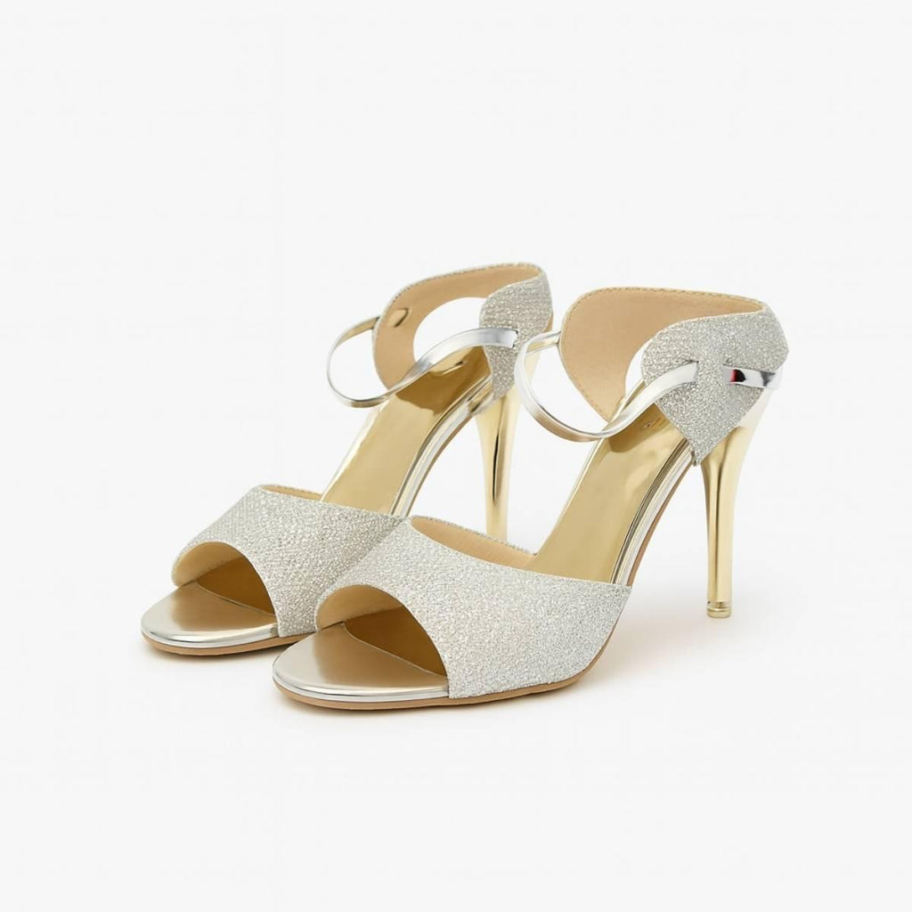 Pair of Nyla Gold Radiance Stiletto Heels with shimmering silver straps and gold stiletto design