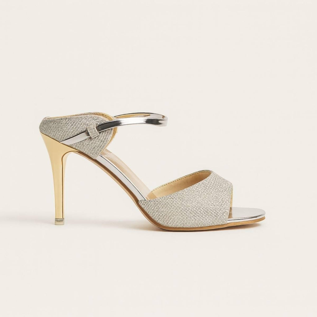 Side view of Oh! Divine Nyla Gold Radiance Stiletto Heel featuring metallic gold heel and silver strap