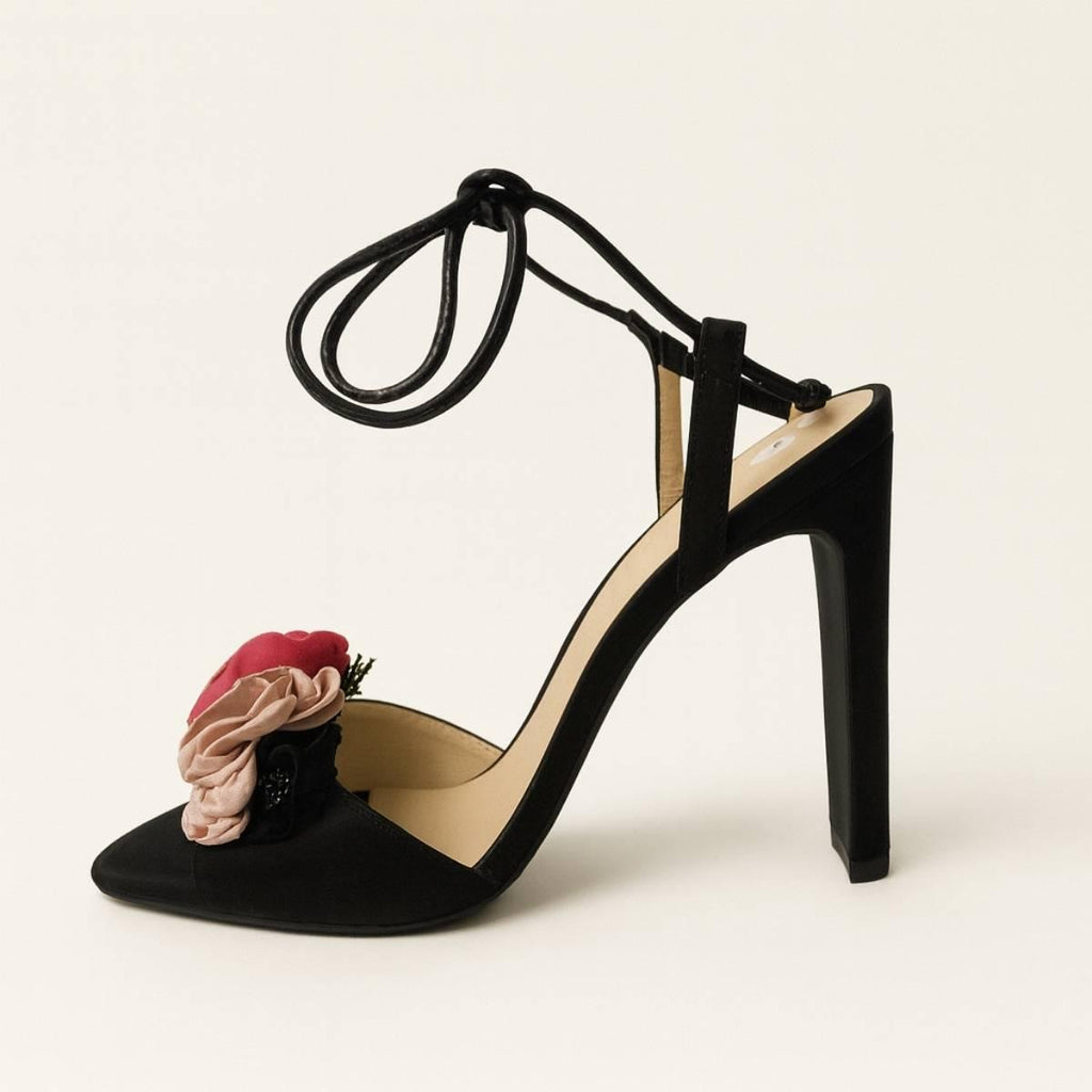Side view of Oh! Divine floral black high-heel sandal with 3D flower detail and sleek satin finish.