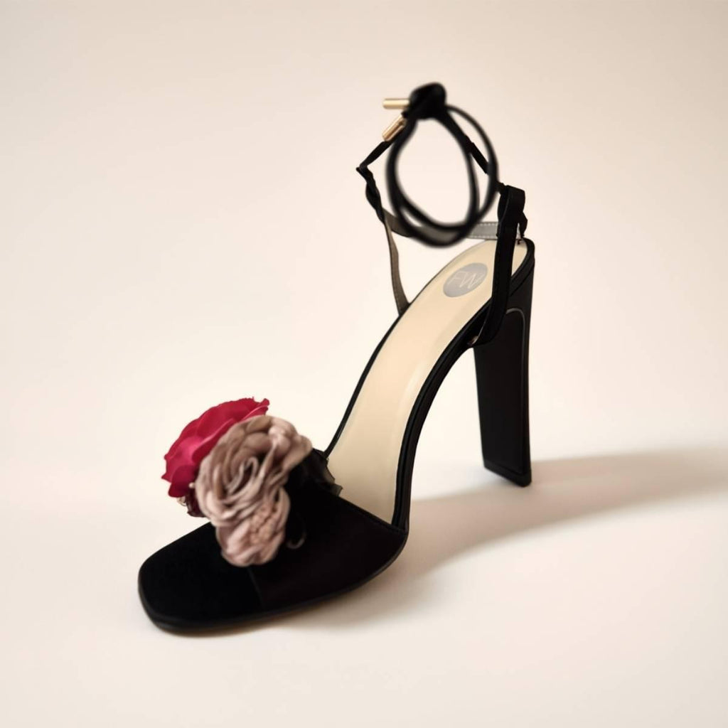 Elegant Oh! Divine black high heels with pink and beige floral accents and soft matte finish.