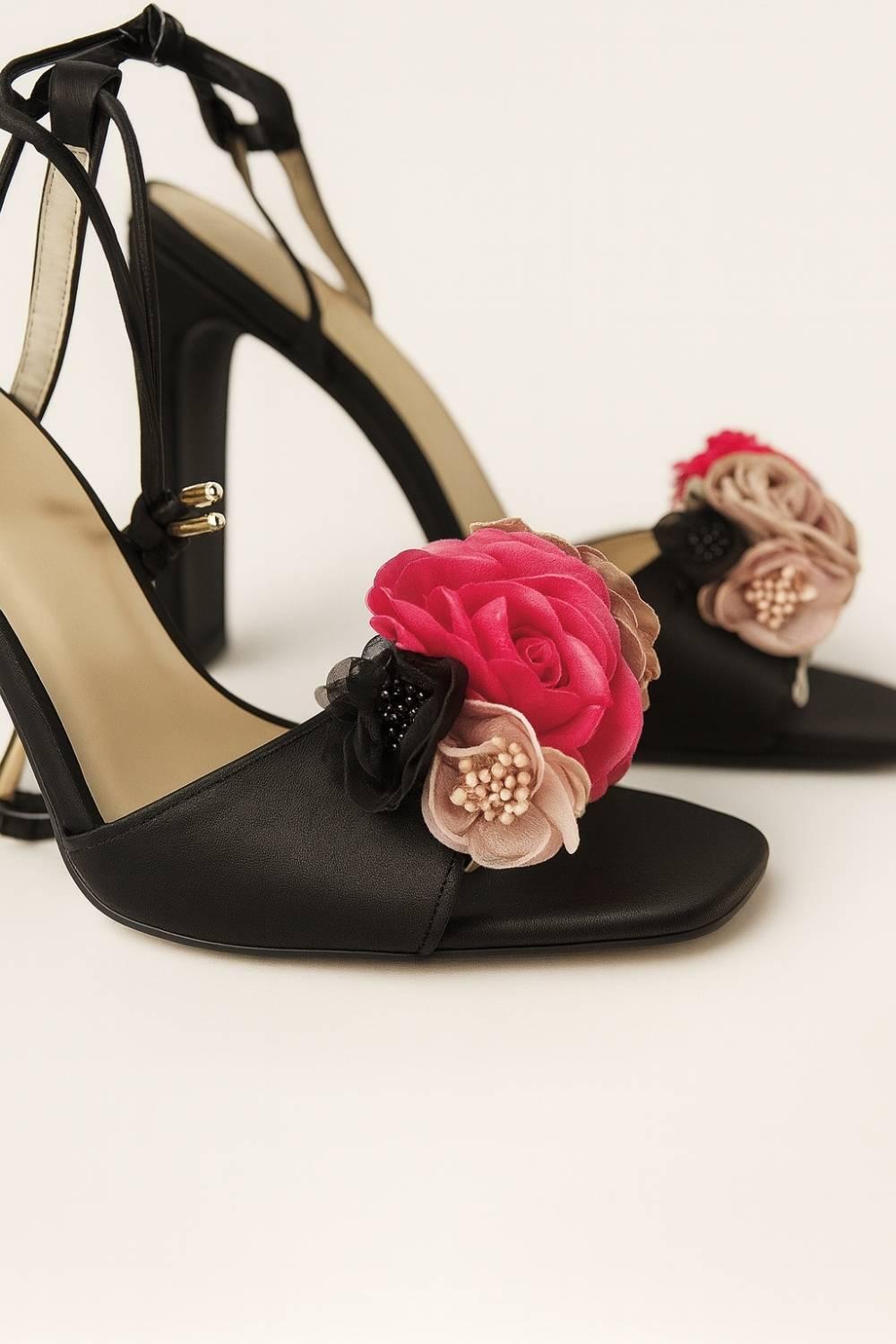 Close-up of Oh! Divine floral-embellished black heels with layered fabric flowers in blush, rose, and black.