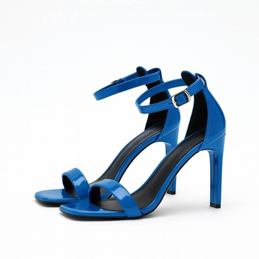 Close-up of Valentina Cobalt Blue Heels focusing on the polished patent finish and gold ankle buckle detail