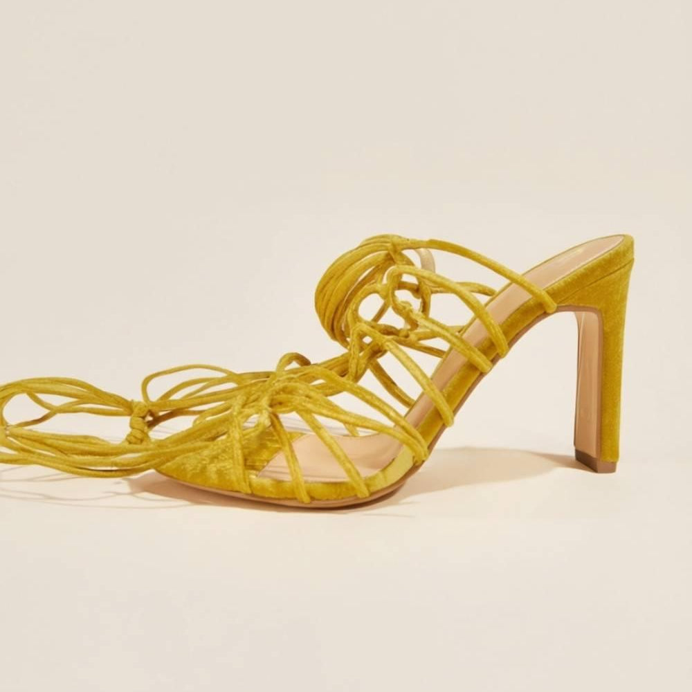 Flat lay of Zuri Mustard Lace Heels displaying lace-up straps and rich suede texture