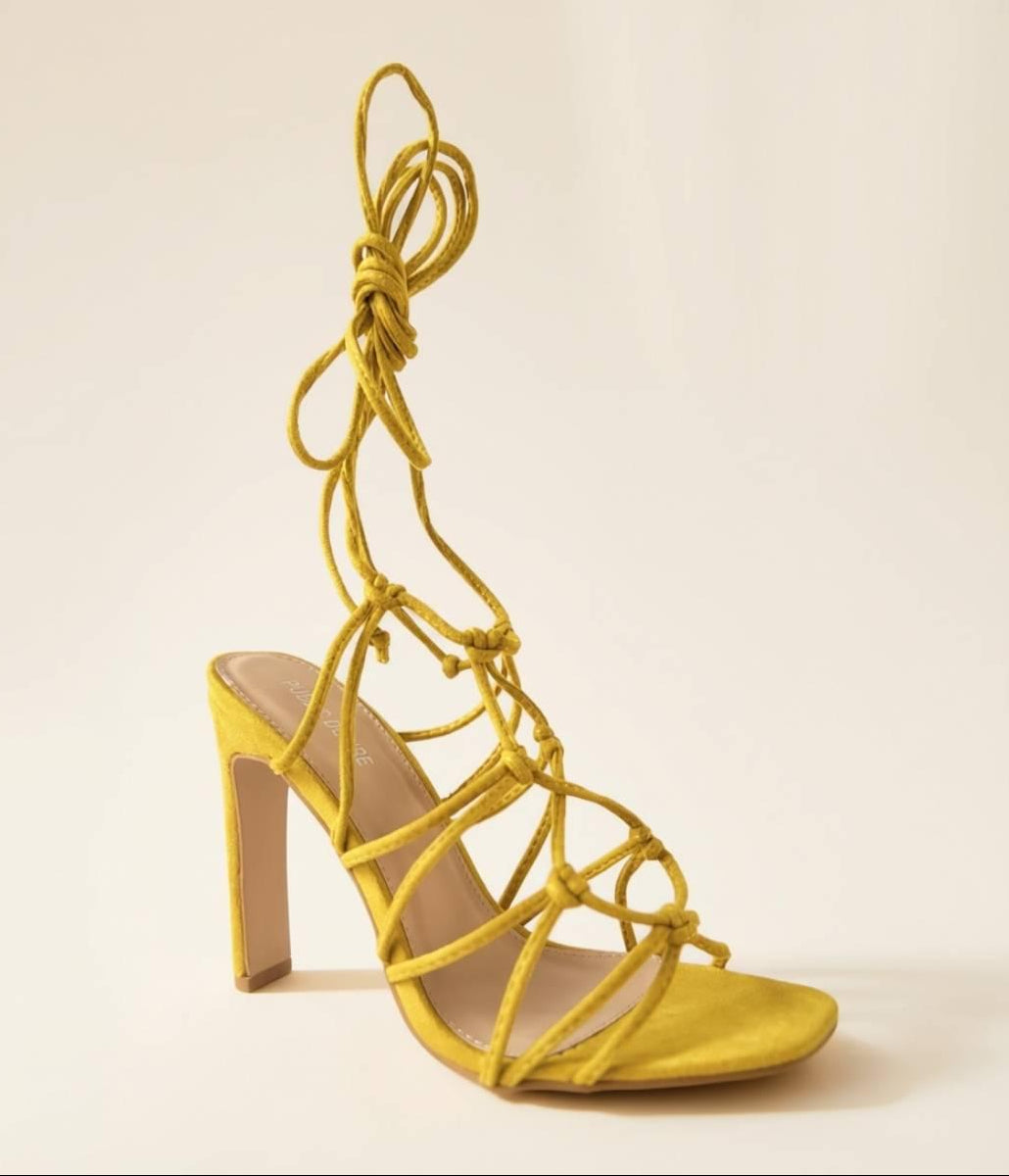 Front angle view of Oh! Divine Zuri Mustard Lace Heels featuring intricate lace-up straps and block heel design
