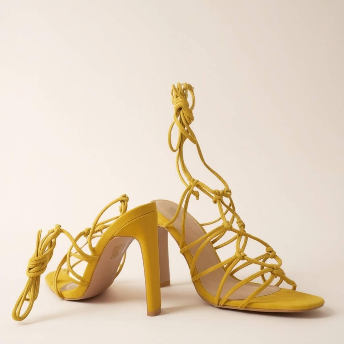 Pair of Zuri Mustard Lace Heels showcasing strappy design, square toe, and elegant mustard faux suede finish