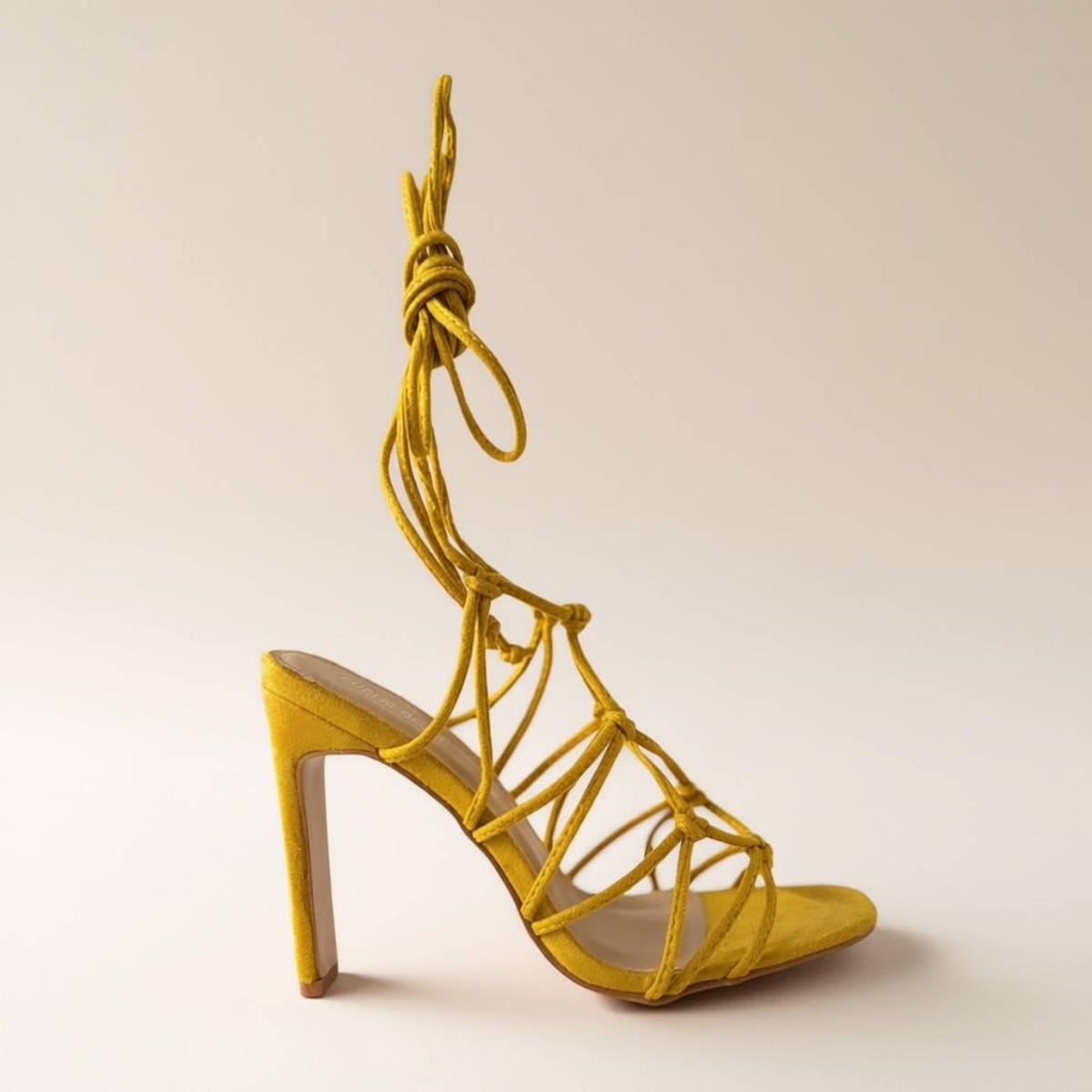 Side profile of Zuri Mustard Lace Heels with wrap-around ankle ties and elevated block heel