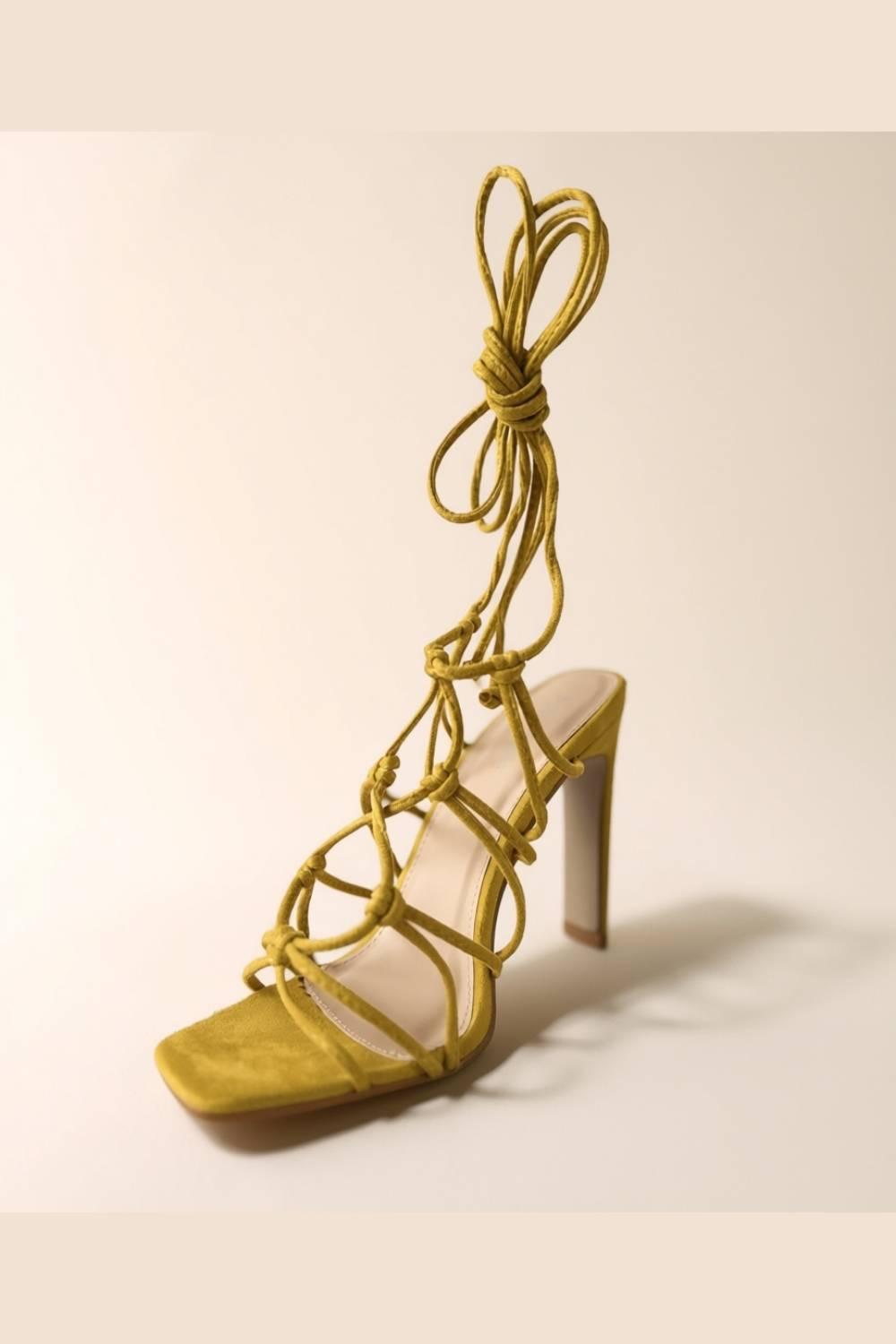 Studio shot of Oh! Divine Zuri Mustard Lace Heels emphasizing sculpted heel and wrap-around lace tie
